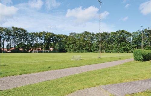 a field with a soccer field with a goal at Holiday Home Halvejen Hytte Spjald in Spjald