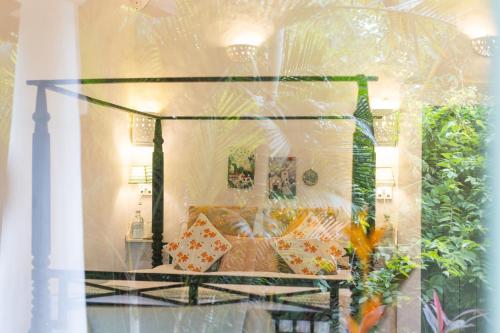 a display window of a room with a bed with pillows at Wildflower Villas - All Villa Hotel, Family Run in Candolim