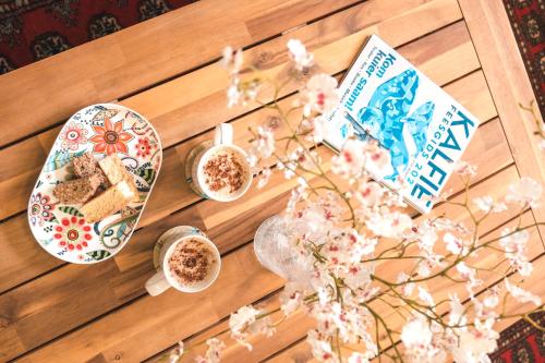 a table with plates of food and cups of coffee at Hermanus Reefs in Hermanus