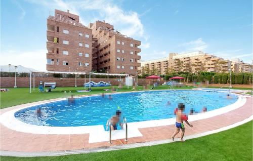 a man is standing in front of a swimming pool at Beautiful Apartment In Oropesa Del Mar in Oropesa del Mar