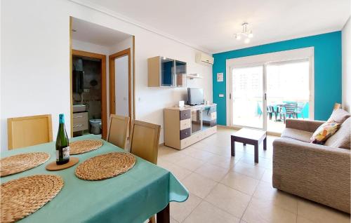 a living room with a table and a couch at Beautiful Apartment In Oropesa Del Mar in Oropesa del Mar