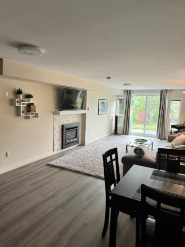 a living room with a couch and a fireplace at Bright private suite near Departure Bay beach in Nanaimo
