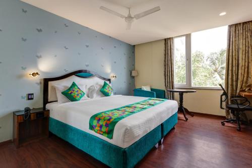 a bedroom with a large bed and a window at HOTEL BLACK & WHITE in Visakhapatnam