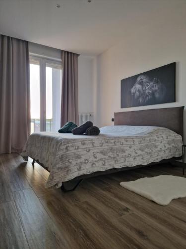 a bedroom with a large bed and a large window at Residenza La Chiave in Mantova