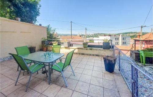 un patio avec une table et des chaises sur un balcon dans l'établissement Awesome Apartment In Saint-Étienne, à Saint-Étienne