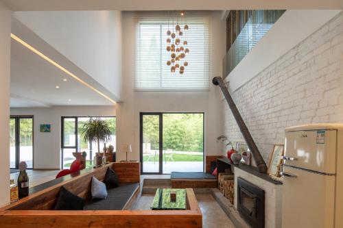 a living room with a couch and a fireplace at Vretreats yunxishang Boutique Hotel in Deqing