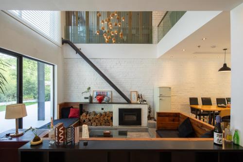 a living room with a couch and a fireplace at Vretreats yunxishang Boutique Hotel in Deqing