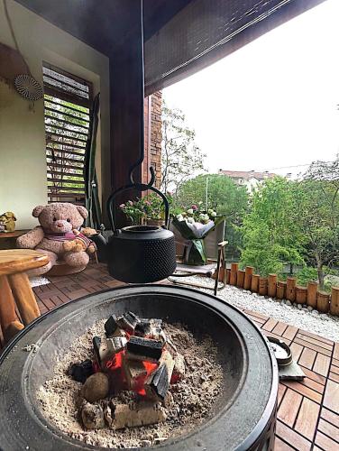 a teddy bear sitting next to a fire pit at 哲帆民宿花园洋房江与城店 in Chongqing