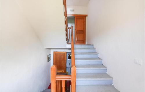 a staircase in a house with a chair and a stair case at Casa Di Bergotto in Roccaprebalza
