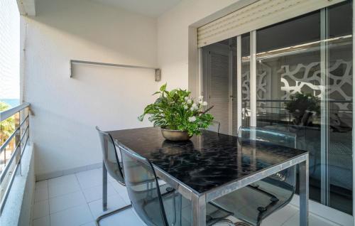 a dining room table with a potted plant on it at Cozy Apartment In Fuengirola With Wifi in Fuengirola