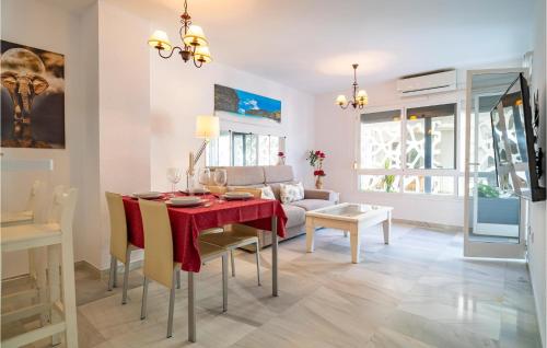 a dining room and living room with a table and a couch at Cozy Apartment In Fuengirola With Wifi in Fuengirola