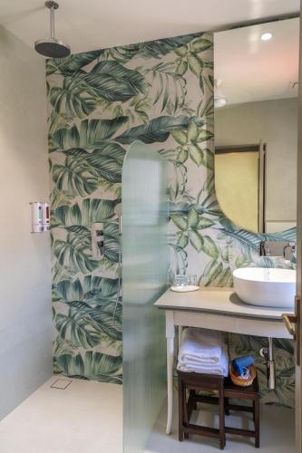 a bathroom with a sink and a mirror at Girisadan Boutique Stay in Jaipur