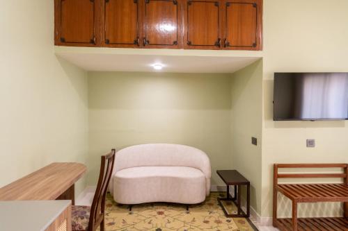 a living room with a chair and a table at Girisadan Boutique Stay in Jaipur