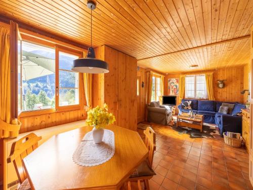 a living room with a table and a couch at Chalet Verrel near Aletsch Ski Gondolas in Fiesch