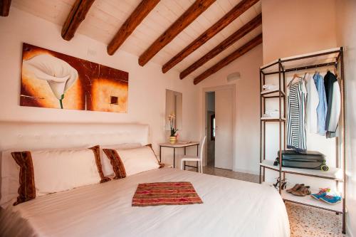 a bedroom with a white bed and a table at Brick House Silea in Silea