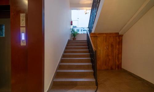 a staircase in a building with a stair case at Treebo Kashvijoy, 7 Km From Kamakhya Temple in Guwahati