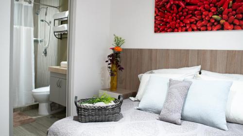 a bedroom with a bed and a vase with flowers on it at Casa Carmelia La Condesa in Mexico City