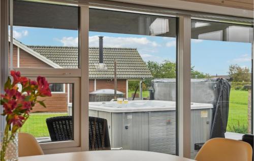 a kitchen with a view of a yard through windows at Three-Bedroom Holiday Home In Vinderup in Vinderup