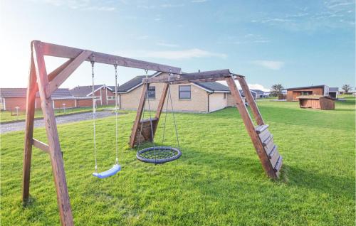 an old swing set in a yard at Three-Bedroom Holiday Home In Vinderup in Vinderup