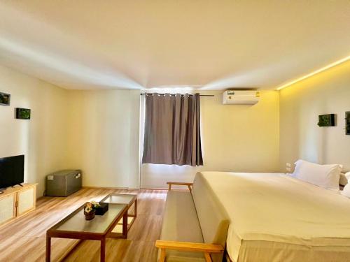 a hotel room with a bed and a tv at patong sunset villa Phuket in Patong Beach
