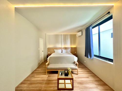 a bedroom with a bed and a large window at patong sunset villa Phuket in Patong Beach