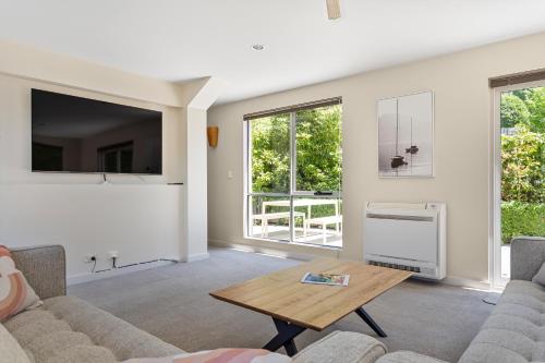a living room with a couch and a table at Tokenburg Townhouse in Launceston