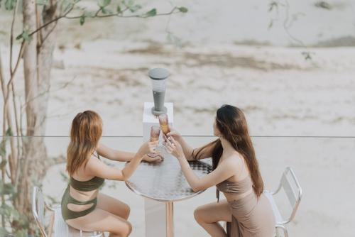 two women sitting at a table with champagne glasses at The French Villa-Santander Cebu in Santander