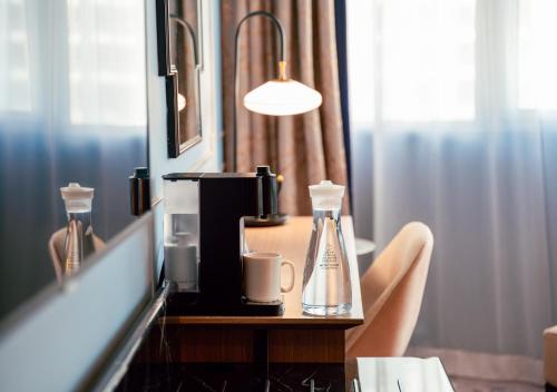 a table with a coffee maker and two cups on it at Copthorne King's Hotel Singapore in Singapore