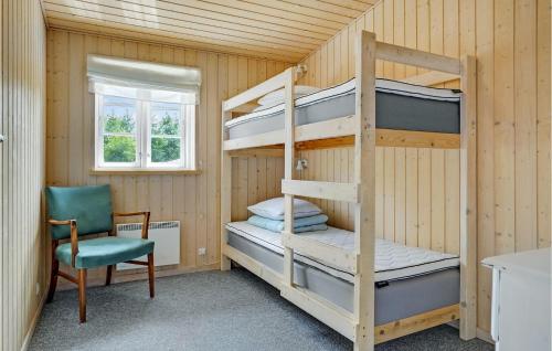 a bunk bed room with a desk and a chair at 4 Bedroom Stunning Home In Glesborg in Glesborg