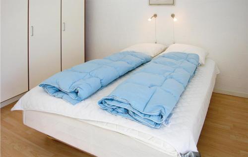 a bed with a sleeping bag on top of it at Holiday Home Stikkelsbærvej Tarm Iv in Hemmet