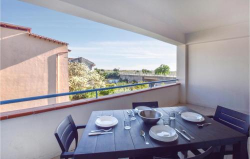 a table with plates and silverware on a balcony at Cozy Apartment In Nocera Terinese in Nocera Terinese