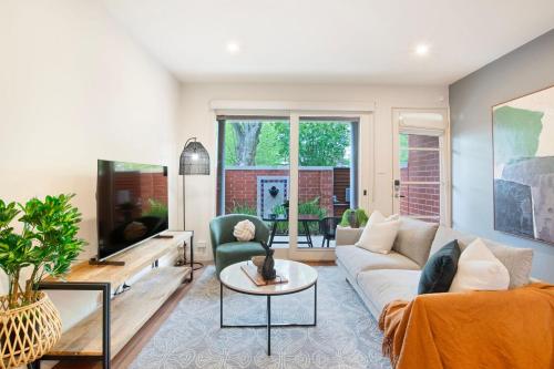 a living room with a couch and a tv at Splendour in Norwood in Norwood