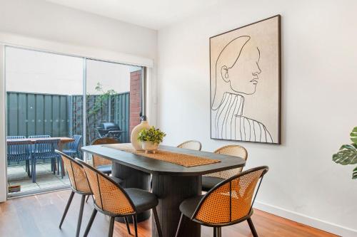 a dining room with a table and chairs at Splendour in Norwood in Norwood