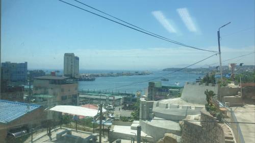 a view of a city with a river and buildings at Donghae ocean house in Donghae