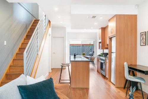 a kitchen and living room with a stairway leading to a living room at Splendour in Norwood in Norwood