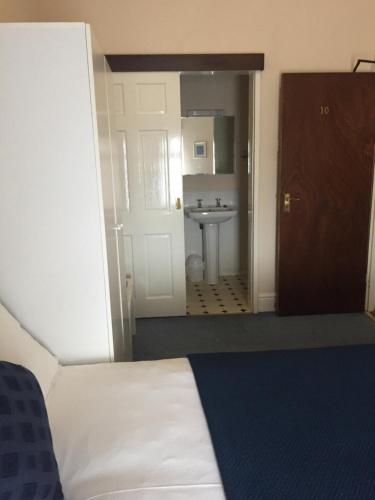 a bathroom with a bed and a sink in a room at Marlow Lodge in Blackpool