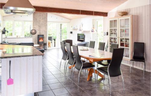 a kitchen and dining room with a table and chairs at Holiday Home Lyngvej Tranekær Ii in Hou