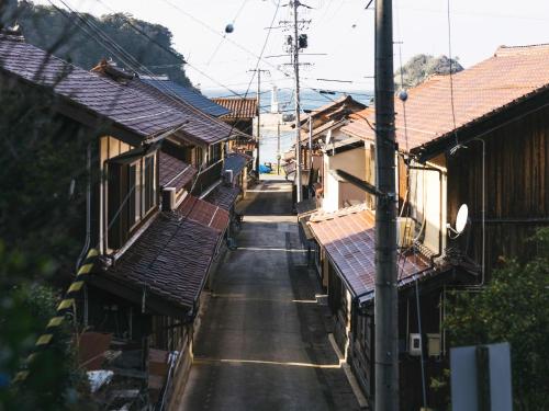 an empty street between two buildings with roofs at RITA Izumo Sagiura in Izumo