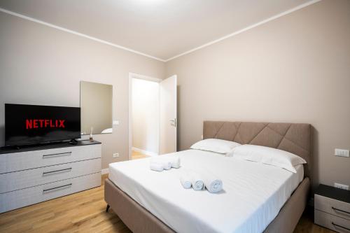 a bedroom with a bed with a tv and shoes on it at Venovela Luxury Retreat in Florence