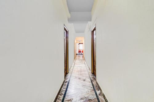 a corridor of a room with white walls and ceilings at Super Hotel O Adarsh Nagar Near Kavya Hospital in Visakhapatnam