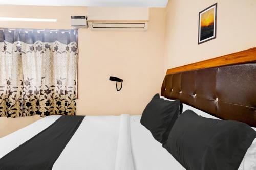 a bedroom with a large bed and a window at Super Hotel O Adarsh Nagar Near Kavya Hospital in Visakhapatnam