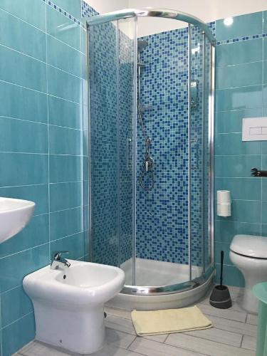 a bathroom with a shower and a toilet and a sink at Top Floor Rentrooms Napoli in Naples