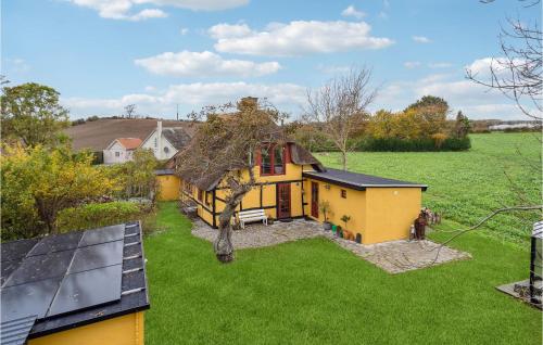 an aerial view of a yellow house with a yard at Lovely Home In Rudkøbing With Wifi in Rudkøbing