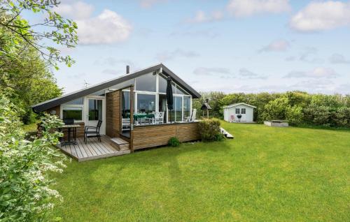 a modular home with a deck on a lawn at Stunning Home In Vestervig With Sauna in Vestervig