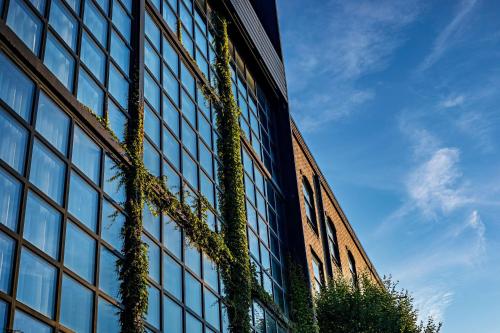 a tall building with plants on the side of it at The LOOM Hotel, Tapestry Collection by Hilton in Warwick