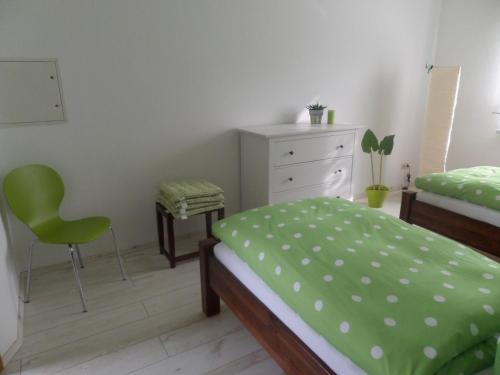 a bedroom with a bed and a dresser and a chair at Elbflair in Zahna-Elster