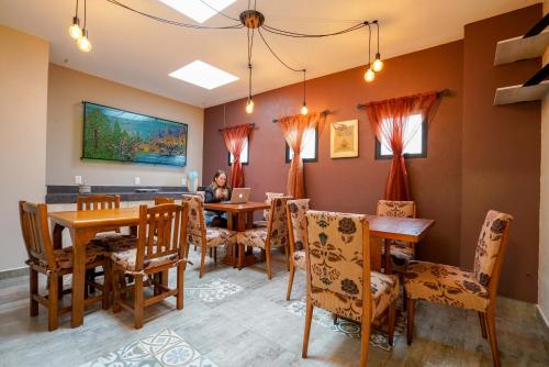 a woman sitting at a table in a dining room at Casa Carmelia La Condesa in Mexico City