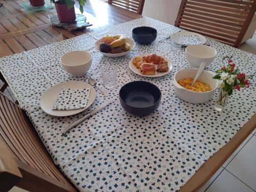 a table with plates and bowls of food on it at La P'tite Etape in Talmont