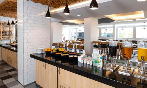 a restaurant with a counter with drinks on it at DoubleTree by Hilton Paris Bougival in Bougival
