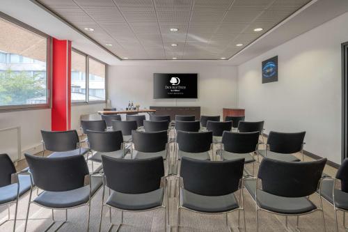 a conference room with chairs and a flat screen tv at DoubleTree by Hilton Paris Bougival in Bougival